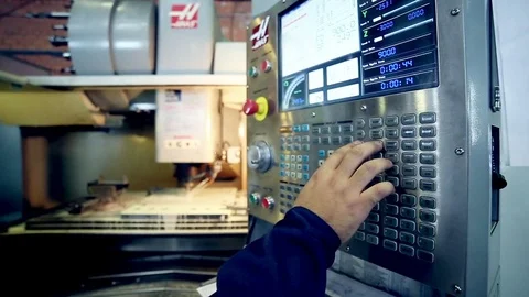Worker operating remote, console of CNC machine Video stock 71577780