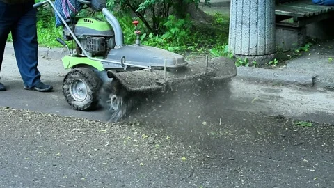 Worker operating small road cleaning machine, Stock Footage 335387299