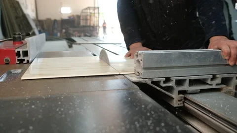 Worker operating table saw cutting wood in bright workshop 動画素材 327592366