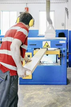 Worker operating a woodworking machine Stock Photos