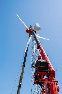Worker operator of the aerial platform at the workplace Stock Photos