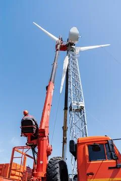 Worker operator of the aerial platform at the workplace Stock Photos