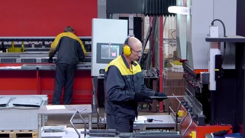 Worker operator bending metal sheet process by sheet bending machine for bus Stock Footage 115212263
