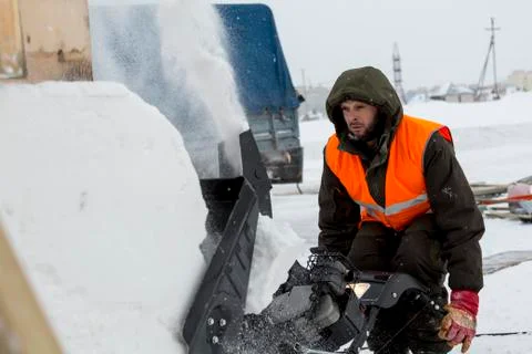 Worker operator snow plow on snow removal 스톡 사진