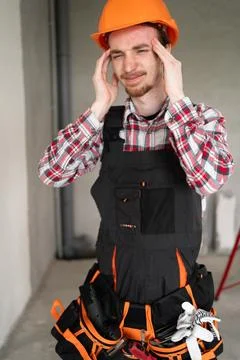 Worker or builder in helmet suffering from migraine and headache. profession, Stock Photos