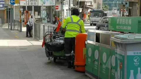 Worker or cleaner collect and sort out rubbish in garbage bin on ro Stock Footage 157536033