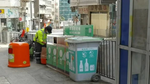 Worker or cleaner collect and sort out rubbish in garbage bin on ro Stock Footage 157536039