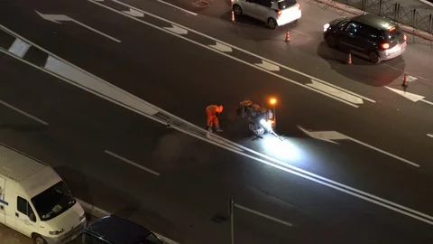 Worker in orange protective uniform using small blinking machine with special Stock-Footage 123710234