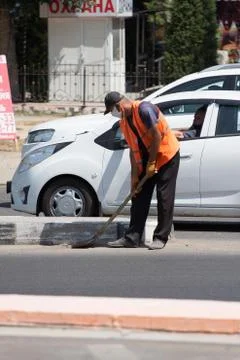 Worker in an orange vest does work on the street.24.06.2020 Tashkent,Uzbekistan Stock Photos