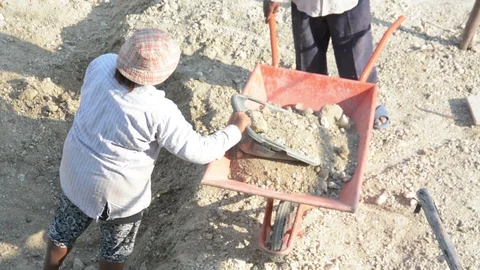 Worker with orange wheelbarrow in construction site Stock Footage 90627155