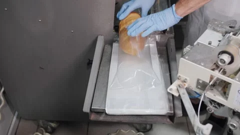 Worker Packaging Fresh Bread Loaf On Production Line. Bakery production. Stock Footage 321735681