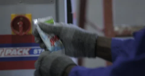 Worker Packing Detergent Plastic Bags (4K) Stock Footage 60936926