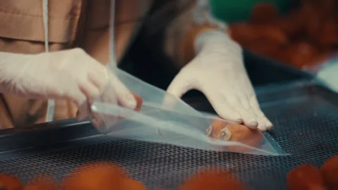 Worker packing dried persimmon fruit in plastic bags Stock Footage 332138224