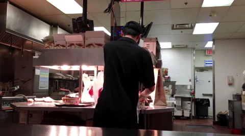 Worker packing food for customer inside KFC chicken restaurant Stock Footage 65220863