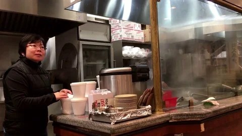 Worker packing food for customer inside Hon's Chinese restaurant Stock Footage 70800952