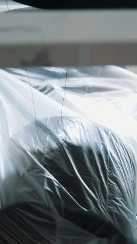 A worker packs spools of yarn. Textile factory equipment. Textile factory. Stock Footage 318463055