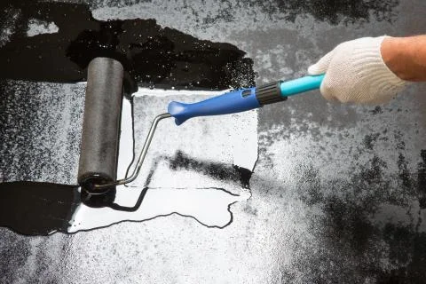 Worker with paint roller do covered floors Stock Photos