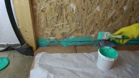 Worker with paintbrush waterproofing  bathroom construction Stock Footage 77984335
