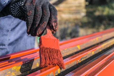 Worker painter covers protective paint metal structures Stock Photos