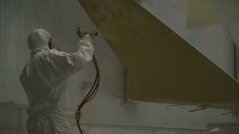 A worker is painting an airplane. Stock Footage 157283454