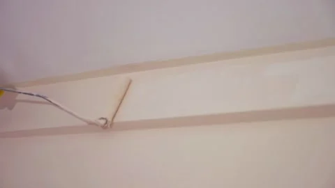 Worker painting the ceiling frame using the roller brush - slow motion Video stock 132194194