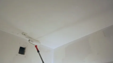 Worker painting ceiling with white paint Stock Footage 128417731