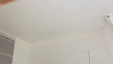 Worker painting ceiling with white paint 库存影片 128417754