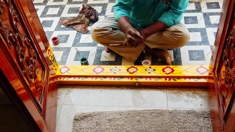 Worker Painting Decorative Doorstep Threshold Design (Gadapa) at Home Entrance Stock Footage 333789225