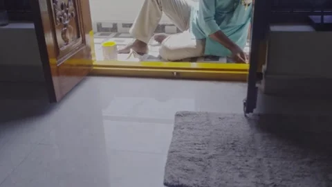 Worker Painting Doorstep Threshold (Gadapa Painting) at Home Entrance Stock Footage 333807271