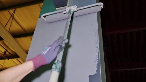 Worker Painting Industrial Column With Roller During Interior Renovation Work Stock Footage 337572728