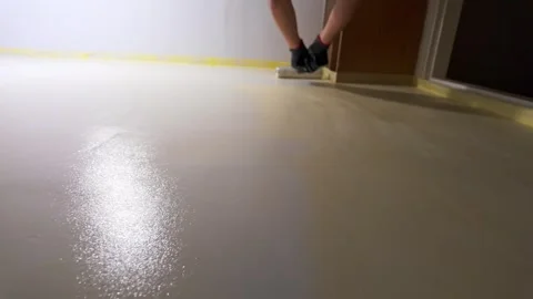 Worker painting interior wall with roller in residential room Stock Footage 335315257