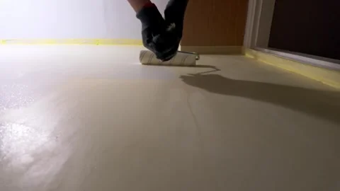 Worker painting interior wall with roller in residential room Stock Footage 335315405