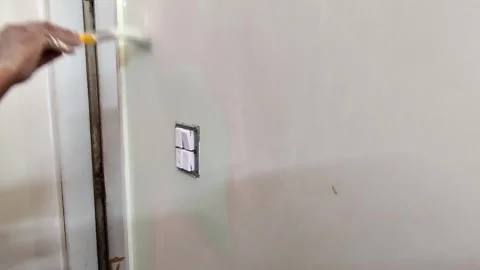 Worker painting tight wall edge near door frame Stock Footage 332425147