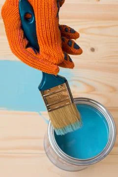 Worker paints board Stock Photos