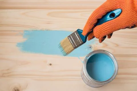 Worker paints board Stock Photos