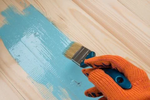 Worker paints board Stock Photos