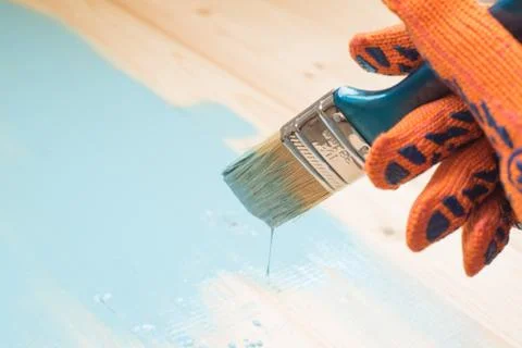 Worker paints board Stock Photos