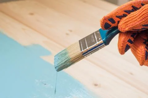 Worker paints board Stock Photos