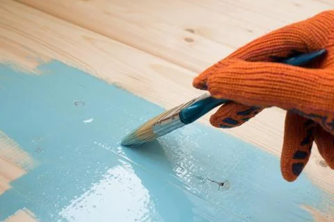 Worker paints board Stock Photos