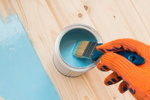 Worker paints board Stock Photos