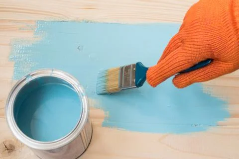 Worker paints board Stock Photos
