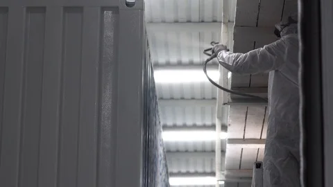 Worker paints a container. White work clothes. Stock Footage 104657223