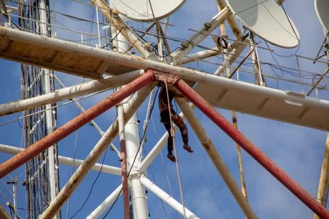 The worker paints pipes at height, is engaged in industrial mountaineering 스톡 사진