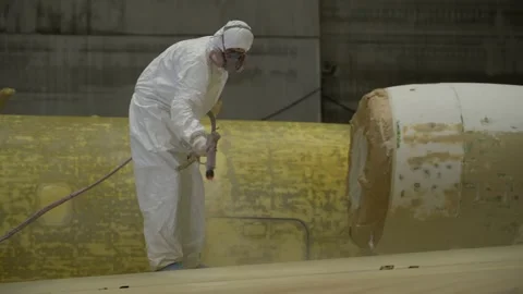 A worker paints the plane white. Video stock 157283394