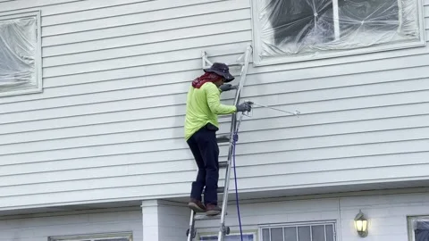 Worker Paints Wall With Paint Spray Gun Stock Footage 218391066