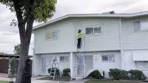 Worker Paints Wall With Paint Spray Gun Stock Footage 218391067