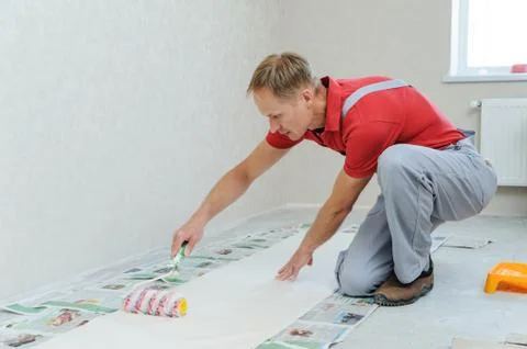 Worker pasting wallpapers. Stock Photos