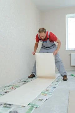 Worker pasting wallpapers. Stock Photos