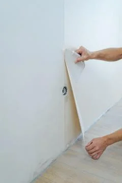 Worker pasting wallpapers. Stock Photos