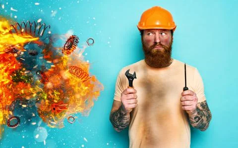 Worker is pensive about his work due to an explosion. concept of doubt and Stock Photos